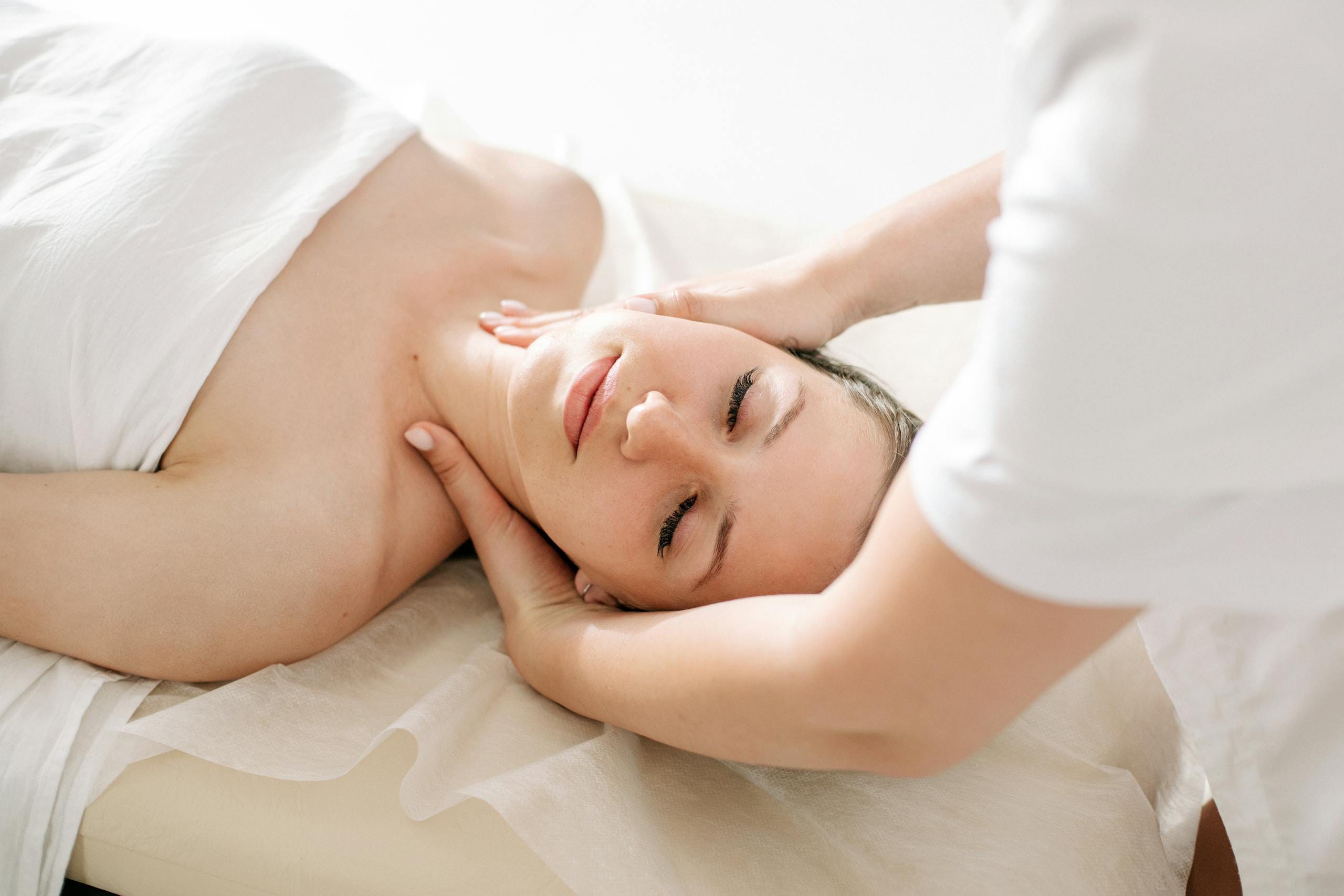A serene spa treatment capturing a woman receiving a relaxing massage, symbolizing therapeutic wellness.